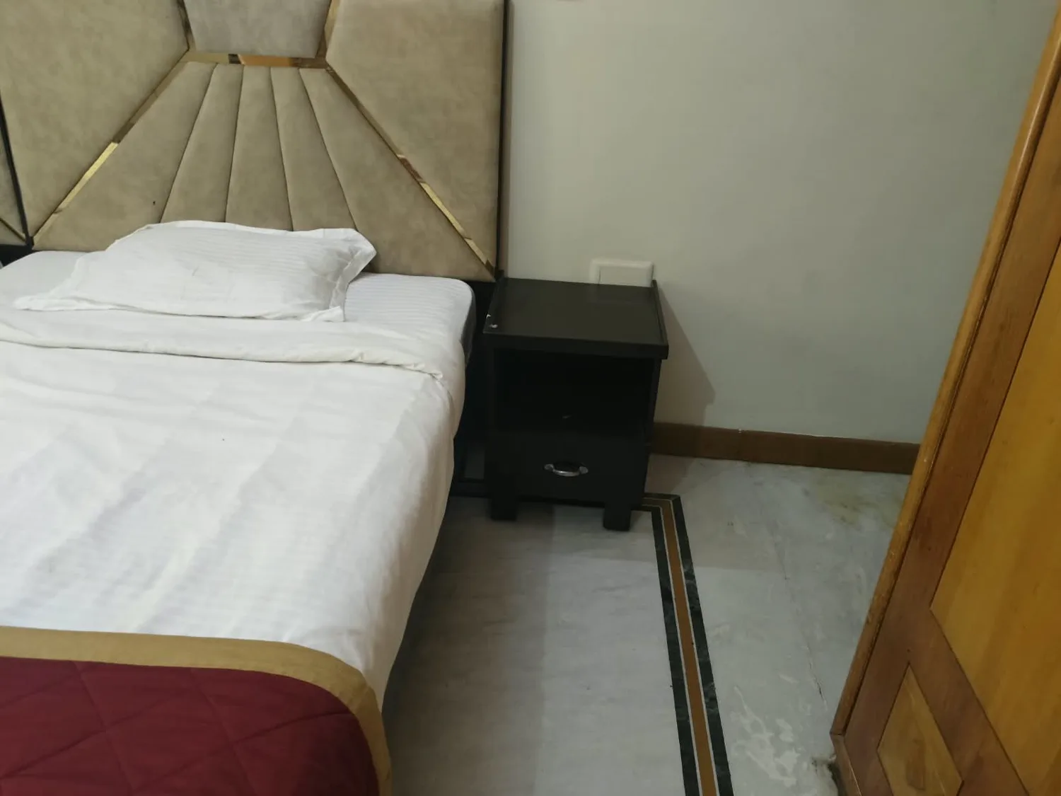 Real guest bedroom with upholstered headboard